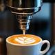 Close-up of coffee beans and a barista at an independent coffee shop.